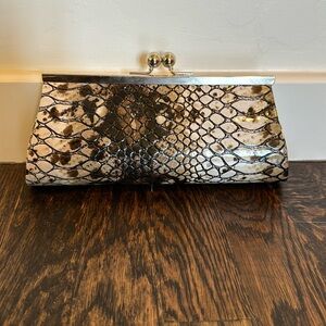 Brown/tan reptile-like print clutch w/ short silver chain. Never worn/like new.